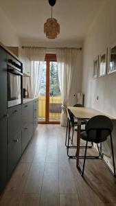 a kitchen with a table and chairs and a window at Central Apartment with a Magnificent View in Graz