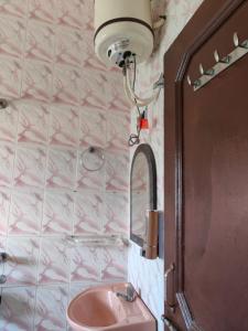 a bathroom with a pink sink and a mirror at Sunny Pines Resort in Lansdowne