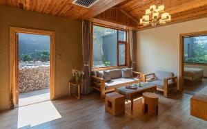 a living room with a couch and a table at Moon Villa in Yangshuo