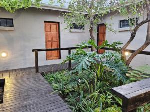 a house with a wooden walkway in front of it at The Blyde Canyon House in Hoedspruit