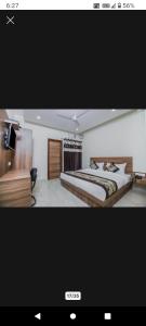 a television screen showing a bedroom with a bed at Hotel Mint Residency - Dwarka Sector 9 in New Delhi