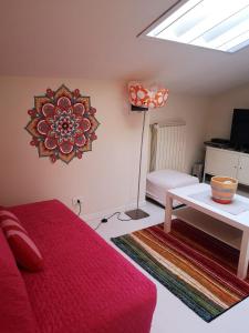 a bedroom with a red bed and a table and a window at Residence S.Cristina in Carmignano