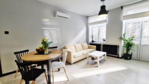 a living room with a table and a couch at Lokum z ogrodem in Płock