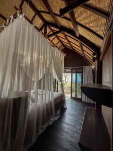 a bedroom with a bed with a mosquito net at Divinity Villas - Uluwatu, Bali in Uluwatu +97 photos