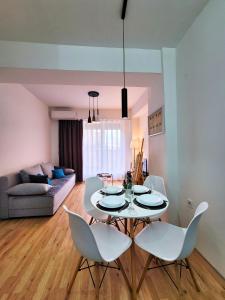 a living room with a white table and chairs at Modern & Stylish - Art Atelier Apartment in Skopje