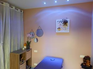 a room with a blue chair and a wall at L'Ardétente - Le cosy, Piscine et SPA en Ardèche, Adults only in Lussas +31 photos