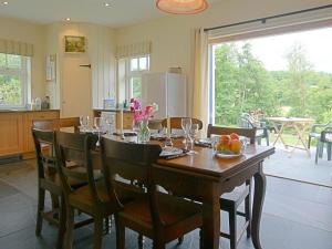 a dining room with a table with a bowl of fruit at Penwaun Nevern in Nevern