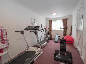 a gym with several exercise bikes in a room at Driftwood Kilgetty in Begelly