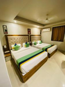 two beds in a room with two beds sidx sidx sidx at New Hotel Amber International Near International Airport T2 in Mumbai