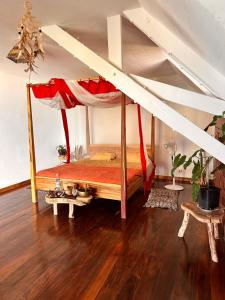 a bedroom with a canopy bed in a room at Shambala Madagascar: Beachfront Lodge And Adventures in Ambolobozo