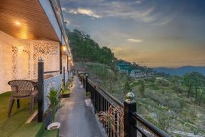 a balcony with a view of the mountains at Moody moon I Kasauli I Amazing Homestay in Kasauli