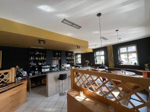 a restaurant with a bar and a counter at Upper-House Goldener Hirsch in Aystetten