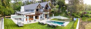 an aerial view of a house with a swimming pool at Simonzicht Guest House in Stellenbosch