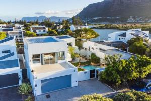 an aerial view of a house with a pool at Near Beach Pool Mountain Views On Canal in Cape Town