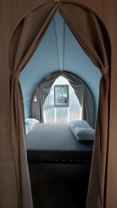 a bedroom with a bed in a tent at Camping Bella Vista in Ceriale