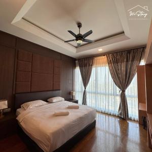 a bedroom with a bed with a ceiling fan and a window at WiStay - NEW COZY 3 BEDROOM APARTMENT AT IMAGO The LOFT B "Seaview and Golf course view" in Kota Kinabalu +20 photos