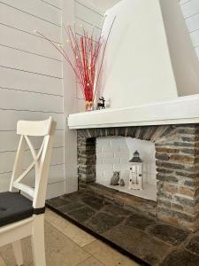 a room with a fireplace with a white mantel at RELAX Seefeld Apartman in Seefeld in Tirol