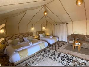 a large bedroom with two beds and a couch at Galaxy stars camp in Hassilabied