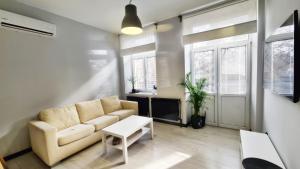a living room with a couch and a table at Lokum z ogrodem in Płock