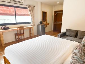 a living room with a bed and a couch at Bounty Resort in Haad Son