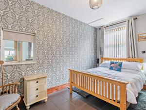 a bedroom with a bed and a chair and a window at 4 Bed in Balderton 94158 in Balderton