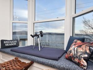 a window seat with a camera and a view of the water at 4 Bed in Aberdovey 94232 in Aberdyfi
