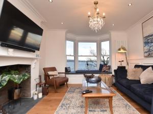 a living room with a couch and a fireplace at 4 Bed in Aberdovey 94232 in Aberdyfi