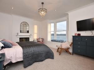a bedroom with a bed and a tv and a fireplace at 4 Bed in Aberdovey 94232 in Aberdyfi
