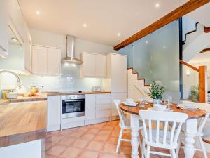 a kitchen and dining room with a table and chairs at 2 Bed in Cirencester 93878 in Coates