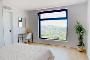 Postel nebo postele na pokoji v ubytování Heterotopia Villas