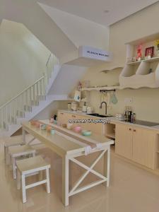 a kitchen with a counter and a sink and a staircase at Jeju Homestay in Hue