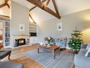 a living room with a fireplace and a christmas tree at 2 Bed in Mickleton 93980 in Mickleton