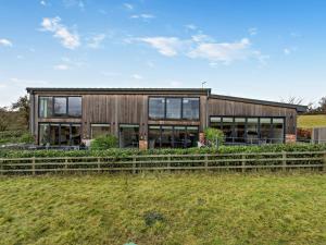 a wooden house with a fence in front of it at 2 Bed in Ticknall 93969 in Ticknall