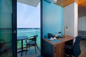 an office with a desk and a table and chairs at h78 veli in Hulhumale