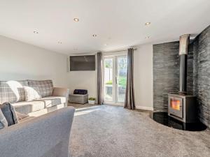 a living room with a couch and a fireplace at 2 Bed in Aberaeron 94044 in Henfynyw Upper