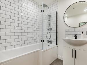 a white bathroom with a tub and a sink at 2 Bed in Buxton 94059 in New Mills +14 photos