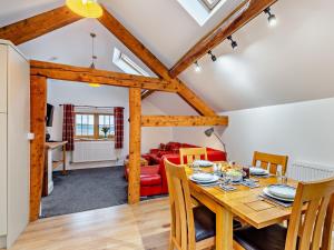 a dining room and living room with a wooden table and chairs at 2 Bed in Clun 94099 in Clun