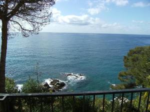 a view of the ocean from a balcony at Apartamentos Cala Llevado in Tossa de Mar