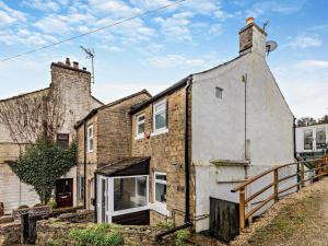 an old stone house with a brick building at 2 Bed in Buxworth 94131 in Buxworth