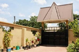 a garage with a large black garage door at Stay in Bomang'ombe with Breakfast in Moshi