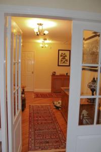 a hallway of a home with a door and a rug at The Marshes - Large home, short drive to beach in Kells