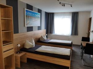 um quarto com duas camas e uma janela em Pension 'Am Stadtrand' em Borchen