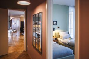 a room with a bed and a mirror and a bedroom at The Circus Apartments in Berlin