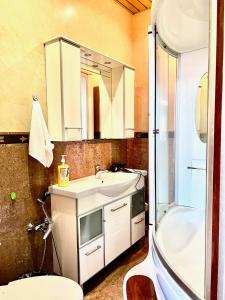une salle de bain avec un lavabo, une douche et des toilettes dans l'établissement 390 Очень теплая квартира с видом на Байтерек с 2 большими кроватями и 2 санузлами, à Astana 6 autres photos