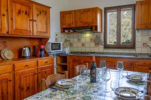 a kitchen with a table with wine glasses on it at [COSTA REI] *500 metri dal mare* Free Parking/Wifi in Costa Rei
