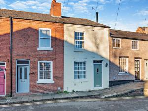 a brick house with a blue door on a street at 2 Bed in Chester 94153 in Chester