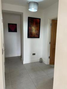 un pasillo con dos pinturas en la pared y un pasillo con en Aghadoe Millers - Modern 3 bed house Killarney, en Fossa
