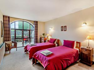 a bedroom with two beds with red sheets at 2 Bed in Malham 94261 in Airton