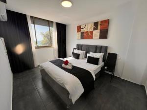 a bedroom with a bed with a teddy bear on it at Elis Boutique Hotel in Bat Yam