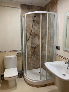 a bathroom with a shower and a toilet and a sink at Home SEA&DREAMS Ifach in Calpe